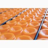 Membrana Schluter Ditra Heat 12.5m2 – detaliu, suprafata portocalie cu caroiaj hexagonal si tevi incalzire