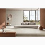 Gresie de exterior Terre Canapa 60x120x2 cm – ambient living, living luminos cu canapea curbata si pereti caramiziu, pe pardoseala