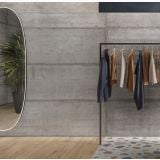 Gresie Form Story Cement 60x120 cm – ambient comercial, perete gri beton, rack haine si oglinda ovala