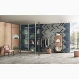 Gresie Lavaredo HLA 5 Grigio 120x120 cm Mat – ambient comercial, showroom modern cu pardoseala gri, perete chevron verde bleumarin