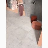 Gresie Ghost Ivory Mat 90x90 cm – ambient comercial, showroom haine cu pardoseala gresie gri si tabureti rosii
