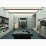 Gresie Portelanata Italgraniti Natural Dark 60x120 – ambient comercial, showroom minimalist cu masa neagra si accesorii expuse, pe pardoseala