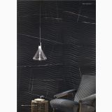 Gresie Sahara Noir Lucios Periat 60x120 cm – ambient living, perete negru texturat ondulat, fotoliu si lampa suspendata