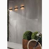 Gresie Rectificata Zinc Mat 60x60 cm – ambient exterior, perete gri exterior cu aplice si bicicleta