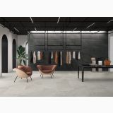 Gresie Shale Moon Mat 80x80 cm – ambient comercial, showroom haine cu pardoseala gri si perete negru texturat